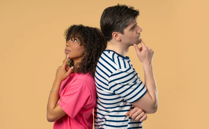 couple standing back to back.